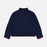 The Hazel Roll Neck Sweater by RAG & BONE is a navy blue cotton-blend sweater with long sleeves, featuring a ribbed collar, hem, and cuffs accented by thin red trim on the cuffs and hem. Shown laid flat with the back side facing up against a white background.