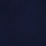 Close-up of a navy blue knit fabric from the RAG & BONE Hazel Roll Neck Sweater, highlighting the texture and stitching, with a ribbed collar edge visible at the top left corner.