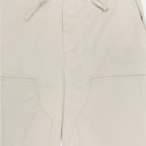 The Jolie Wide Leg Carpenter Pant by RAG & BONE features a beige, relaxed fit with a drawstring waist, wide-leg silhouette, large front patch pockets, visible stitching, and casual lightweight fabric.