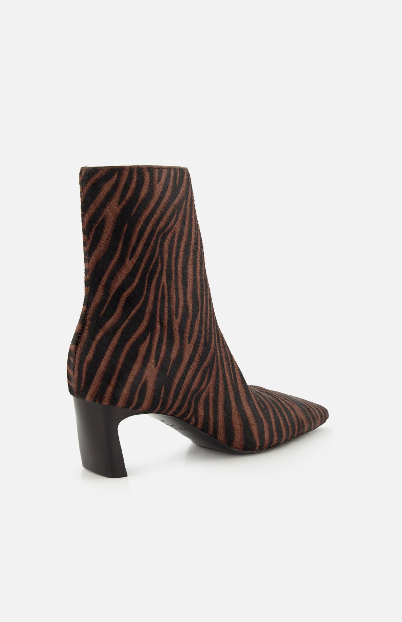 A side view of the Kai Zebra Ankle Boot by RAG & BONE in calf hair features brown and black zebra stripes, a pointed toe, and a chunky mid-height black heel, set against a plain white background.
