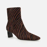 The Kai Zebra Ankle Boot by RAG & BONE features a brown and black zebra print in luxe calf hair, a pointed toe, and a low chunky black heel, shown on a plain white background.