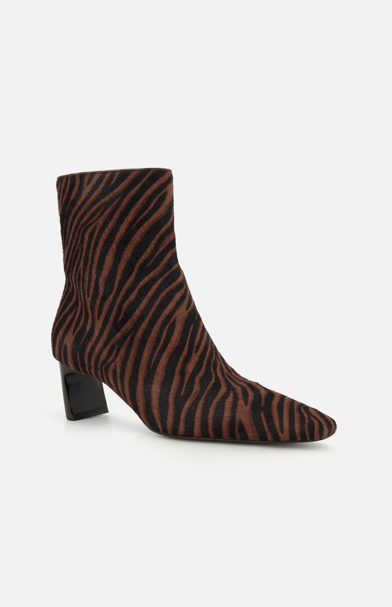 The Kai Zebra Ankle Boot by RAG & BONE features a brown and black zebra print in luxe calf hair, a pointed toe, and a low chunky black heel, shown on a plain white background.