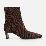 The Kai Zebra Ankle Boot by RAG & BONE features brown and black zebra-print calf hair, a pointed toe, and a low angled block heel, shown from the side on a white background.