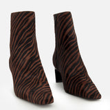 The Kai Zebra Ankle Boot by RAG & BONE features zebra print calf hair, pointed toes, side zippers, and low block heels, displayed on a plain white background.