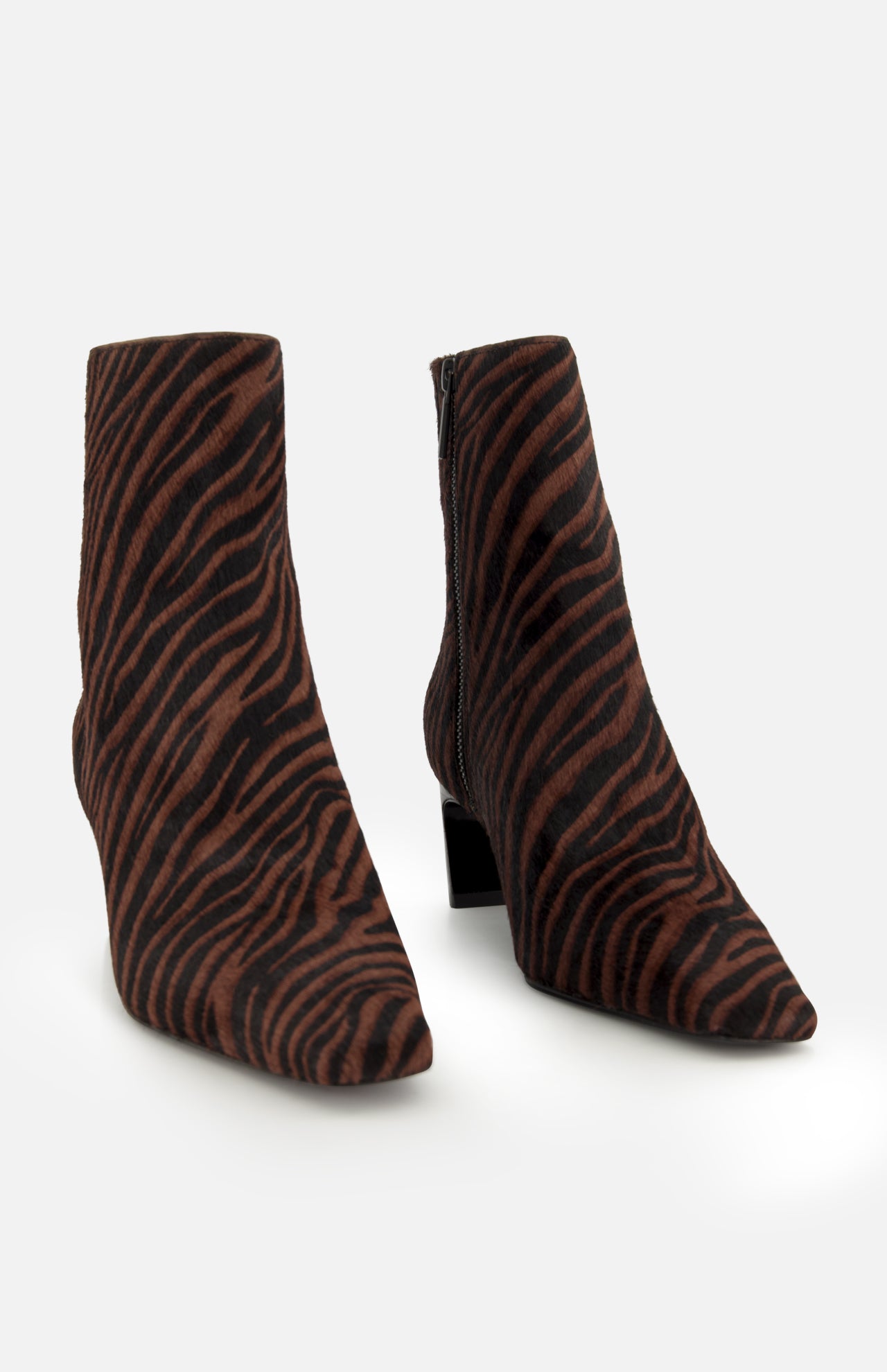 The Kai Zebra Ankle Boot by RAG & BONE features zebra print calf hair, pointed toes, side zippers, and low block heels, displayed on a plain white background.
