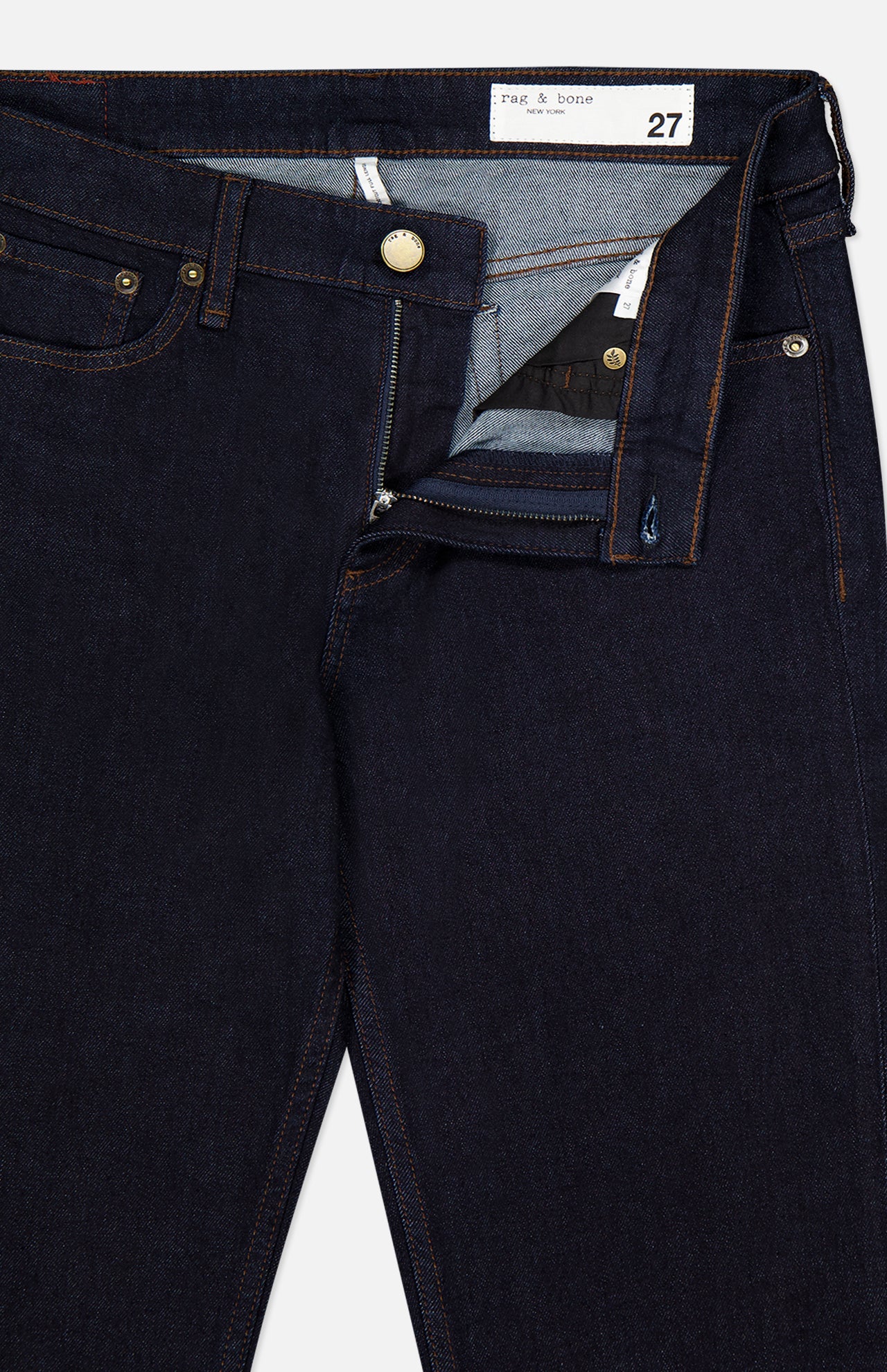 The RAG & BONE Kinsley Low Rise Full Bootcut Jean in Dark Rinse, crafted from vintage stretch denim, features copper rivets and a brass button, with the partially unzipped fly revealing the inside waistband and label. Designed in a size 27 with classic five-pocket styling.