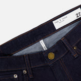 Close-up of a pair of RAG & BONE Kinsley Low Rise Full Bootcut Jeans in Dark Rinse, featuring stretch denim in dark blue, copper rivets, a brass button, front pockets, and a white waistband label displaying the brand name and size 27.