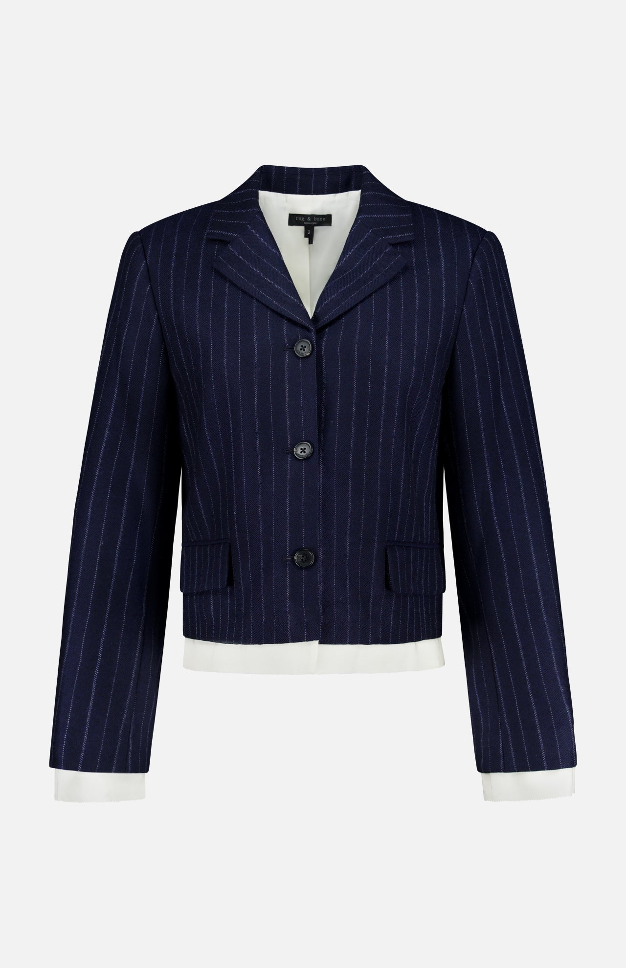The Lawrence Striped Crop Blazer by RAG & BONE features navy pinstripe herringbone, three buttons, a notched collar, flap pockets, and white cuffs and hem—ideal for modern suiting on a clean white background.