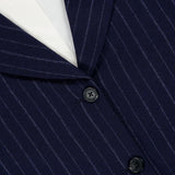 Close-up of the RAG & BONE Lawrence Striped Crop Blazer in pinstripe navy, featuring two black buttons and white lining—perfect for modern women’s suiting.