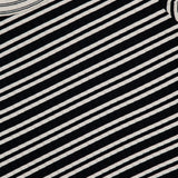 A close-up of the RAG & BONE Luca Stripe Contrast T-shirt shows its black and white horizontal stripes, part of the neckline with a visible tag, and highlights the silky-soft fabric.