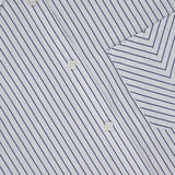 Close-up of the Lucia Stripe Mini Dress by RAG & BONE: a white cotton poplin shirtdress with thin blue stripes, white buttons, and a chest pocket. Diagonal stripes on the pocket and collar contrast with vertical stripes on the main fabric.