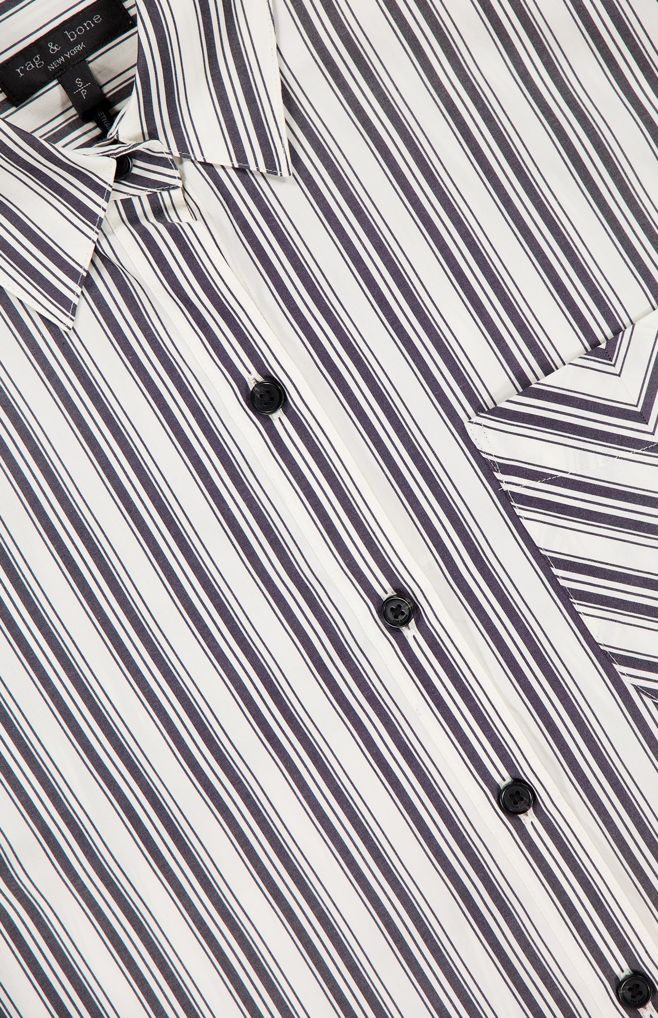 The Lucia Stripe Poplin Shirt by RAG & BONE features vertical black, white, and gray stripes, a chest pocket with diagonal stripes, black buttons, and a modern cropped fit crafted from cotton poplin.