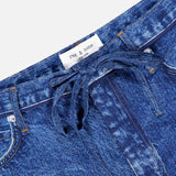 Close-up of the Miramar Slink Lounge Short in York by RAG & BONE. These blue denim-look shorts have a drawstring waist, low-rise fit, classic stitching, pockets, and a white label with the brand name.