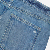 Close-up of the Miramar Terry Drawstring Wide Leg Pant in Ellis by RAG & BONE, showcasing the blue denim look with a back pocket featuring subtle stitching and a small embroidered logo above the pocket.