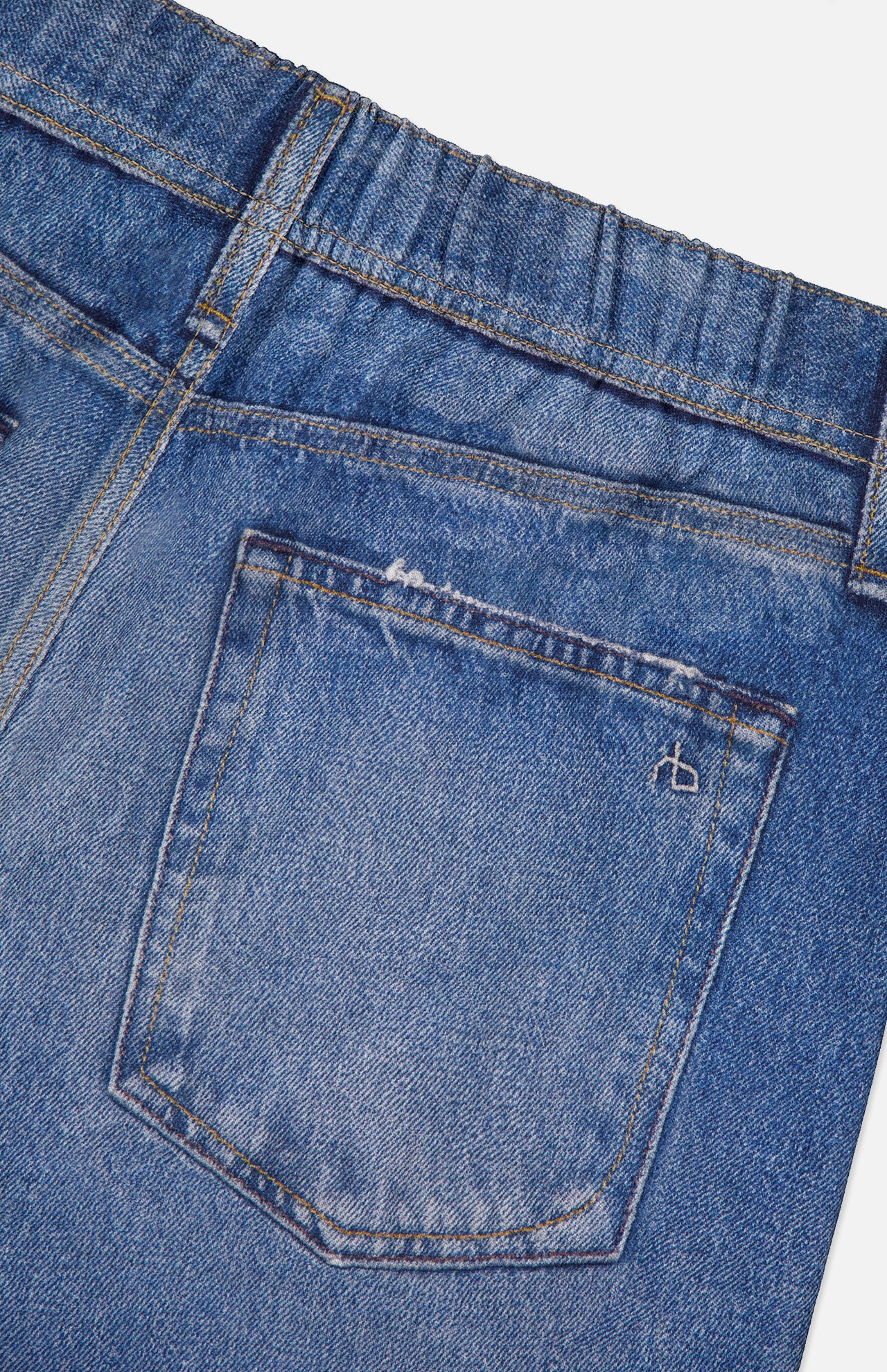 Close-up of the back pocket and waistband on the Miramar Terry Track Pull On Pant in Carst by RAG & BONE, showing faded blue detailing, an elastic waistband section, and a small stitched design on the pocket.