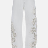 The Shea Full Straight Cut-out Pant by RAG & BONE features high-rise white denim with embroidered floral cut-outs from hip to ankle, classic five-pocket styling, a button closure, and a straight leg silhouette for an elegant look.