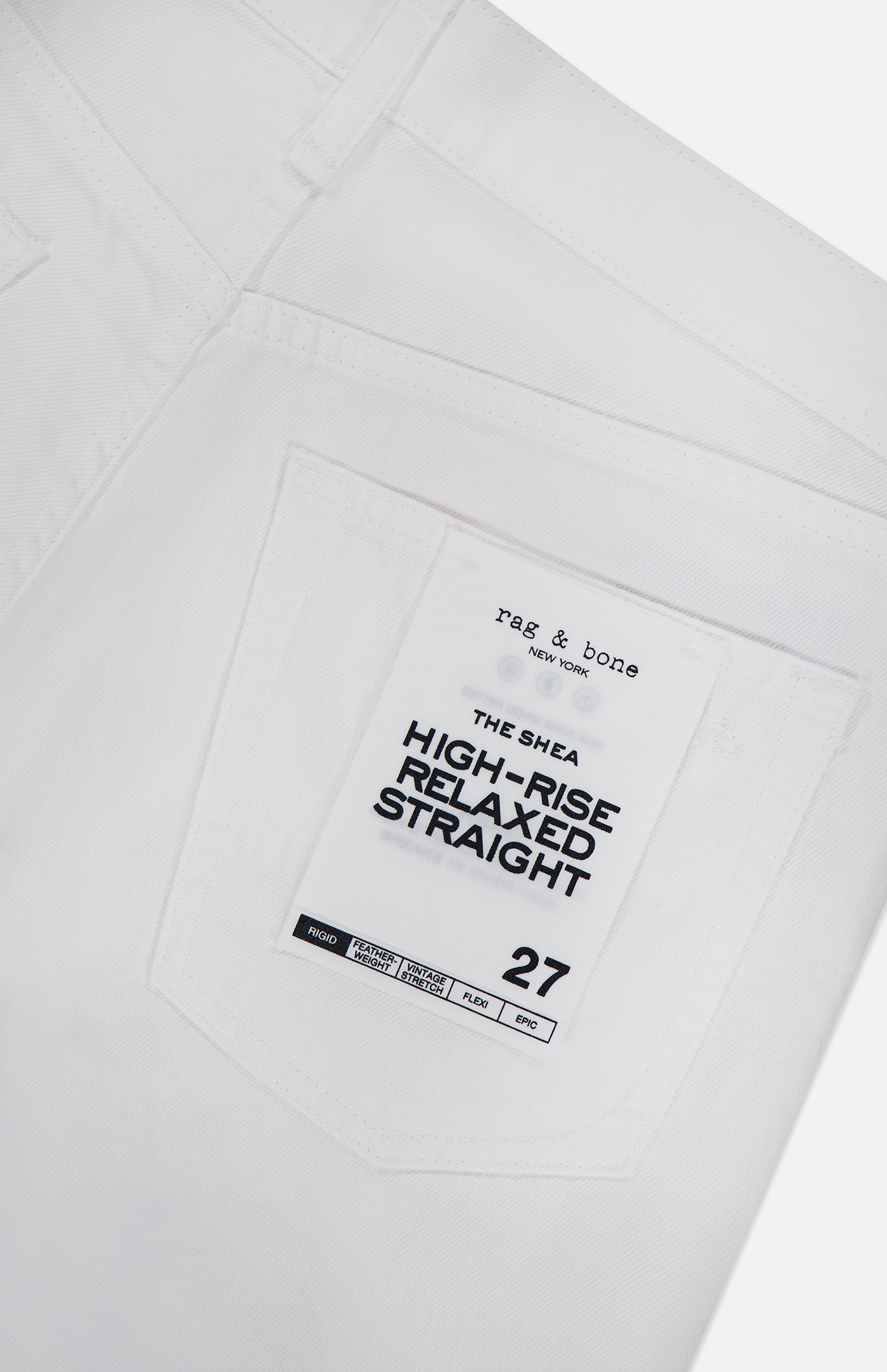 Close-up of the back pocket on Shea Full Straight Cut-out Pant by RAG & BONE, high-rise relaxed fit, featuring a branded tag and size 27.