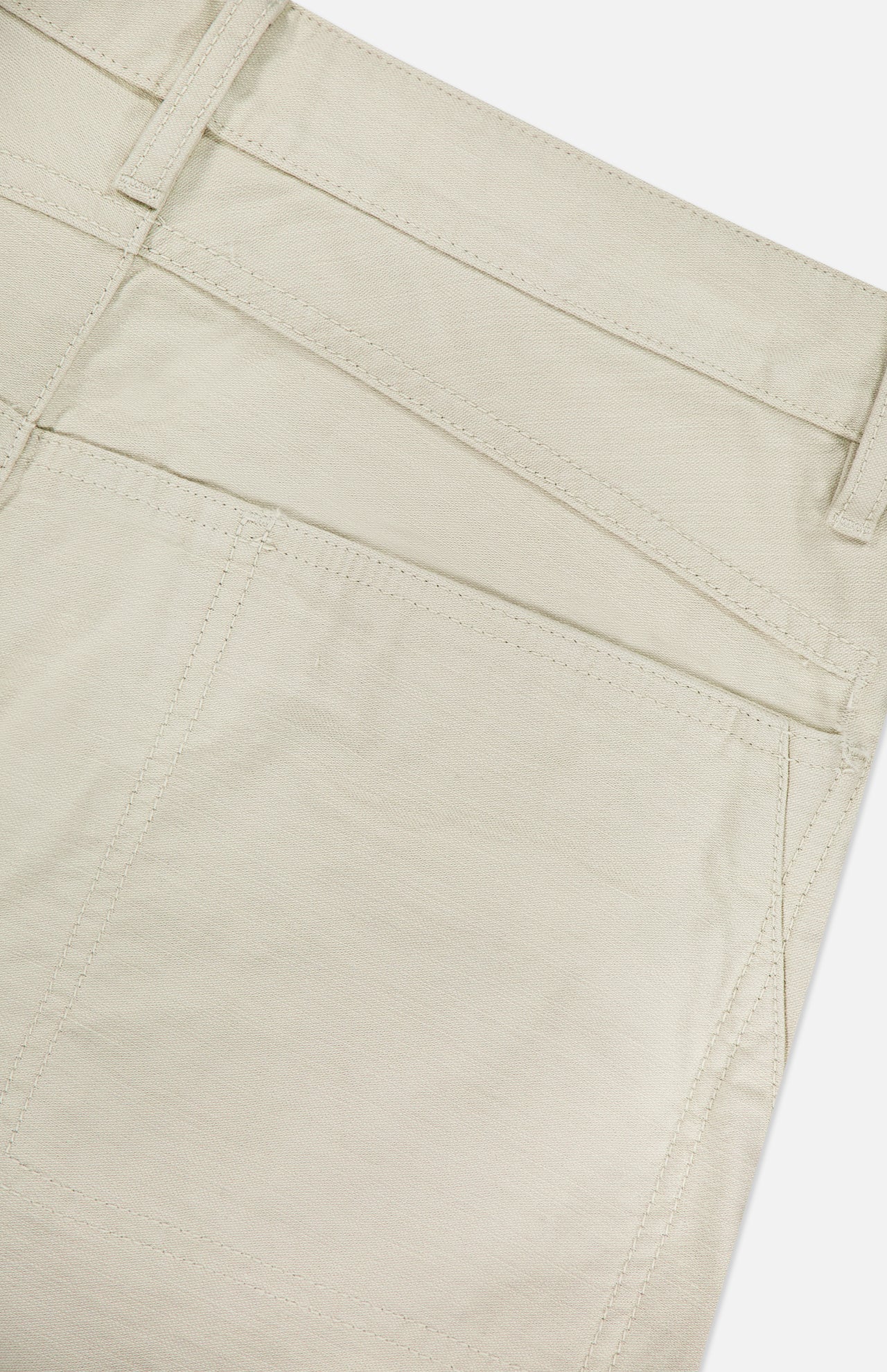 Close-up of the back pocket and waistband on RAG & BONE's Stevie Utility Tapered Pant in light tan 100% cotton, highlighting utility-inspired stitching and belt loops.