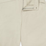 The Stevie Utility Tapered Pant by RAG & BONE is a light tan, utility-inspired pair featuring a visible zipper fly, button closure, belt loops, front pockets, and a partially open waistband showing the inside label.