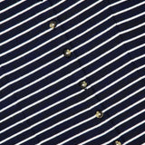 Close-up of the RAG & BONE Knit Button Tie Stripe Dress, showcasing navy blue fabric with white horizontal stripes and a diagonal row of small round buttons.