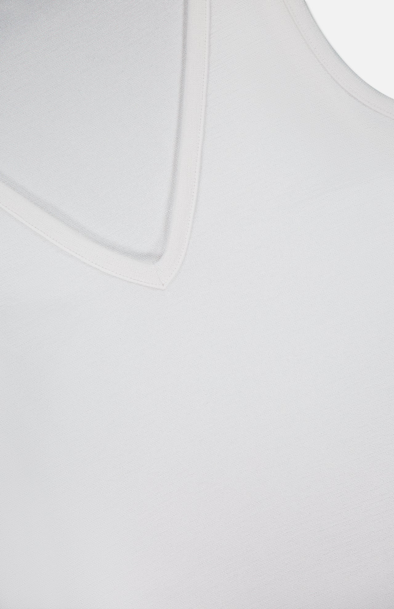 Close-up of the RAG & BONE The Knit V-Neck Tank Top, highlighting its smooth fabric texture and v-neckline against a white background.
