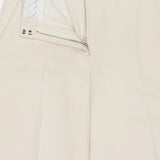 The RAG & BONE Vicky Barrel Leg Ponte Pant in off-white is shown lying flat from the waist down, with an open front zipper and top button revealing the white inner waistband and lining; belt loops are visible at the waist.
