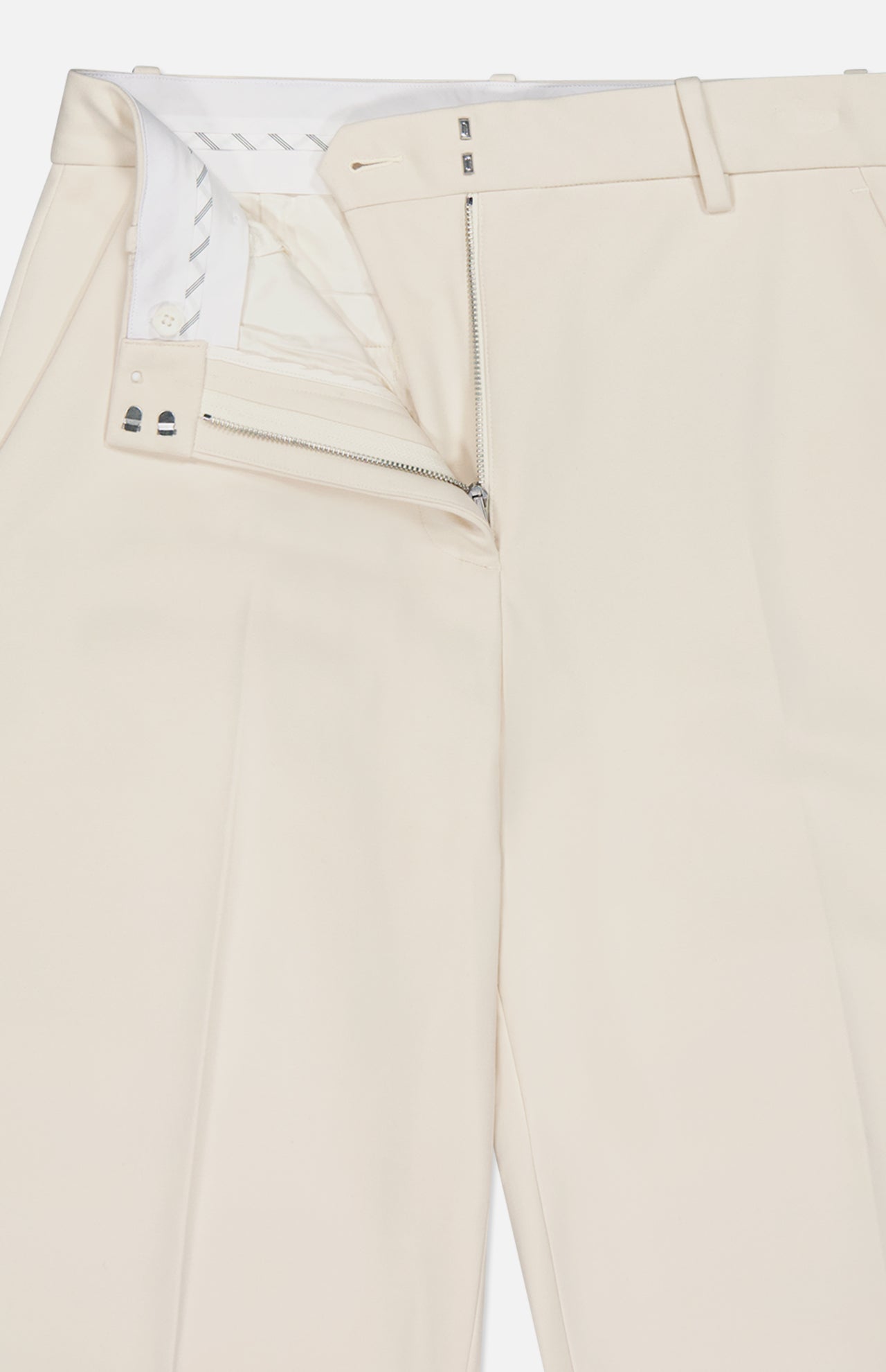 The RAG & BONE Vicky Barrel Leg Ponte Pant in off-white is shown lying flat from the waist down, with an open front zipper and top button revealing the white inner waistband and lining; belt loops are visible at the waist.