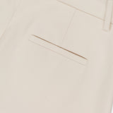Close-up of the back pocket area of the RAG & BONE Vicky Barrel Leg Ponte Pant in off-white, featuring a single welt pocket and belt loops, shown against a plain white background.
