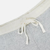 Close-up of the RAG & BONE Vintage Terry Mix Media Sweatshort in light gray, featuring an off-white elastic waistband and white drawstring, showcasing its textured cotton-blend fabric—perfect for casual wear or travel.