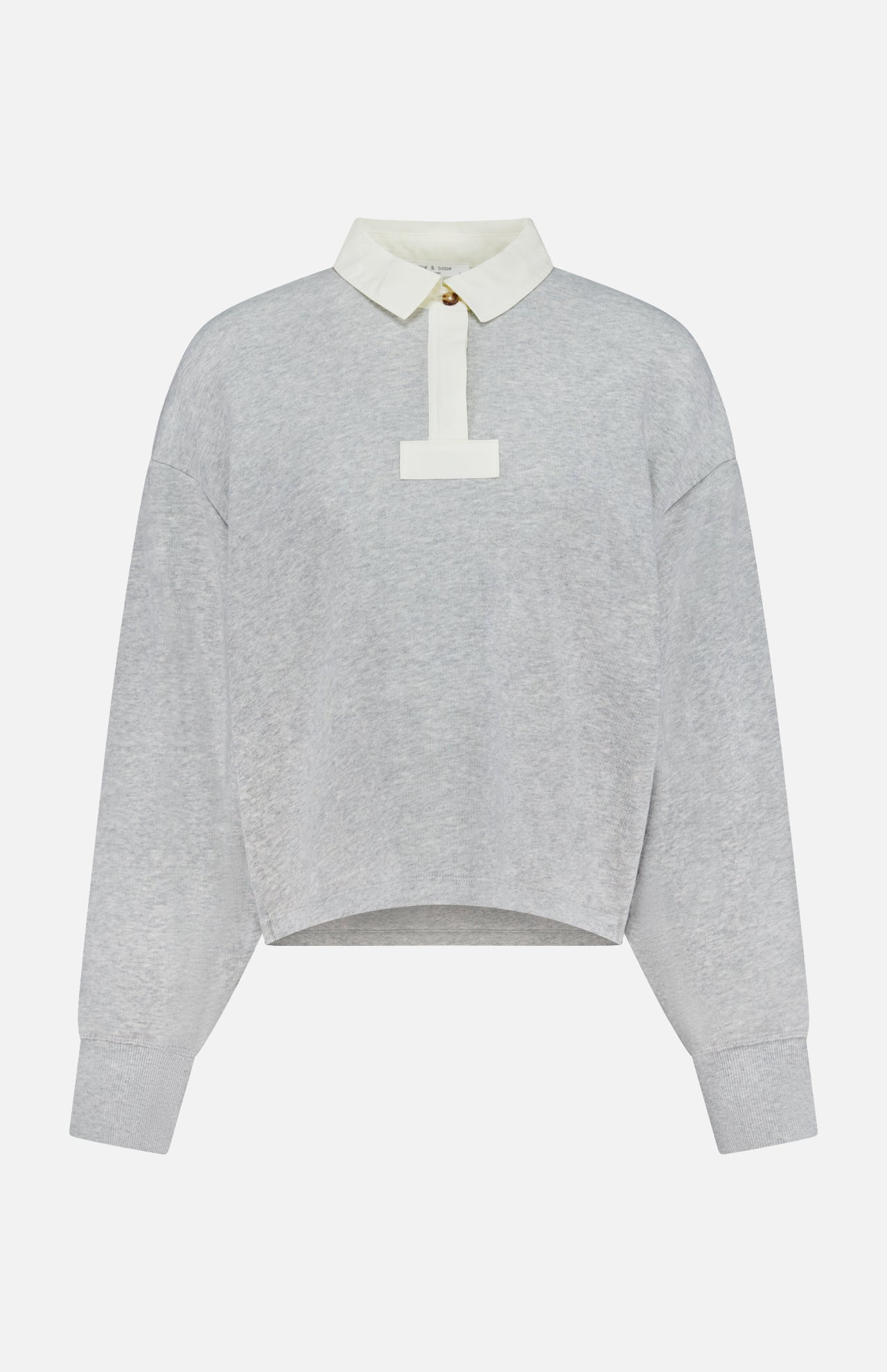 The Vintage Terry Oversized Polo Sweatshirt by RAG & BONE is a light gray cotton-blend terry top with an off-white collar, short button placket, relaxed fit, cuffed sleeves, and a slightly curved hem.