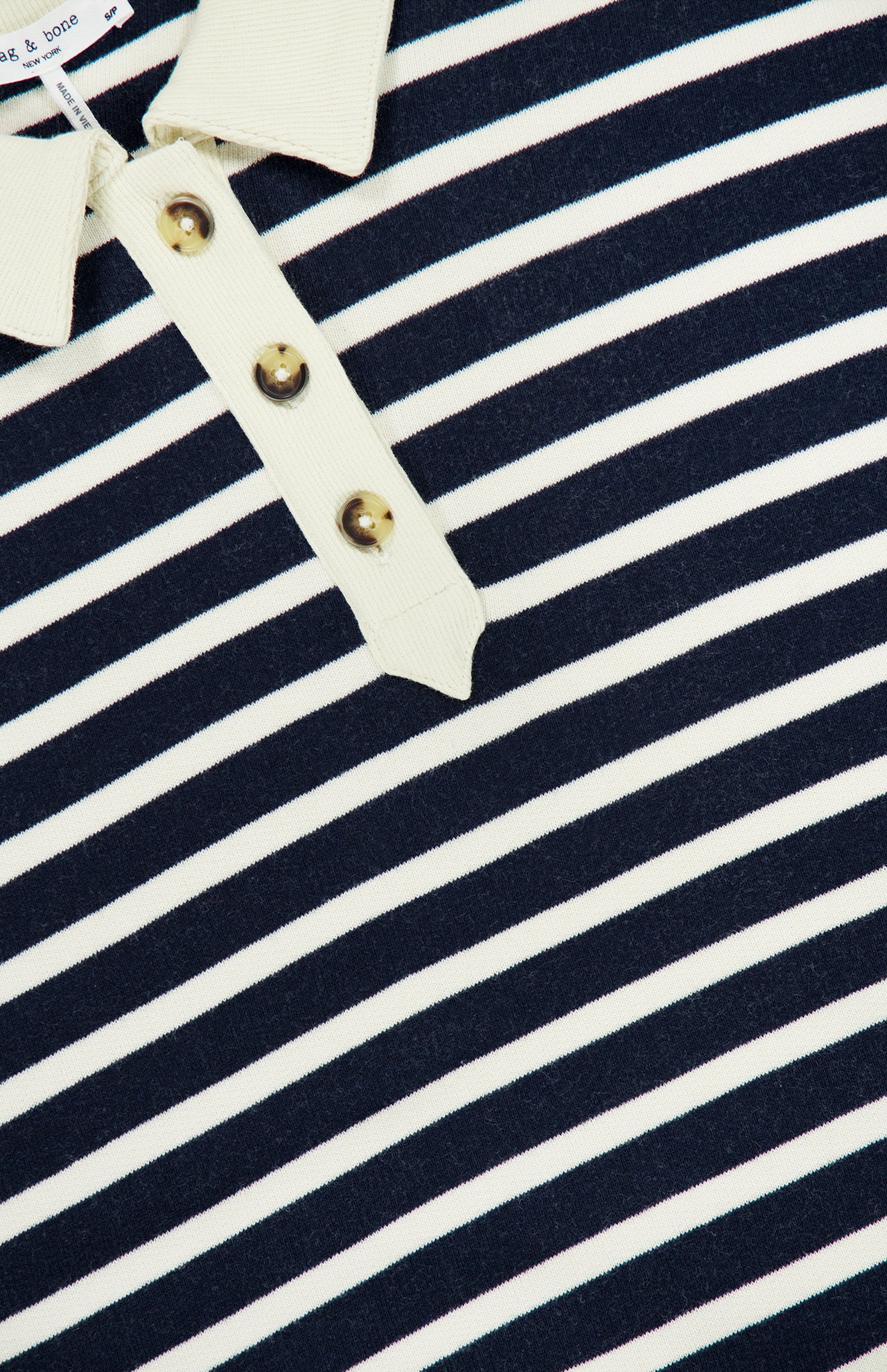 Close-up of the RAG & BONE Vintage Terry Striped Polo Sweatshirt in navy blue and white stripes with a cream collar and three-button front, blending classic comfort with sporty preppy style.