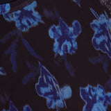 A close-up of the RAG & BONE Yana Printed Mesh Long Sleeve T-shirt, a black stretch mesh top with a blue and purple abstract floral pattern and a partially visible neckline tag.