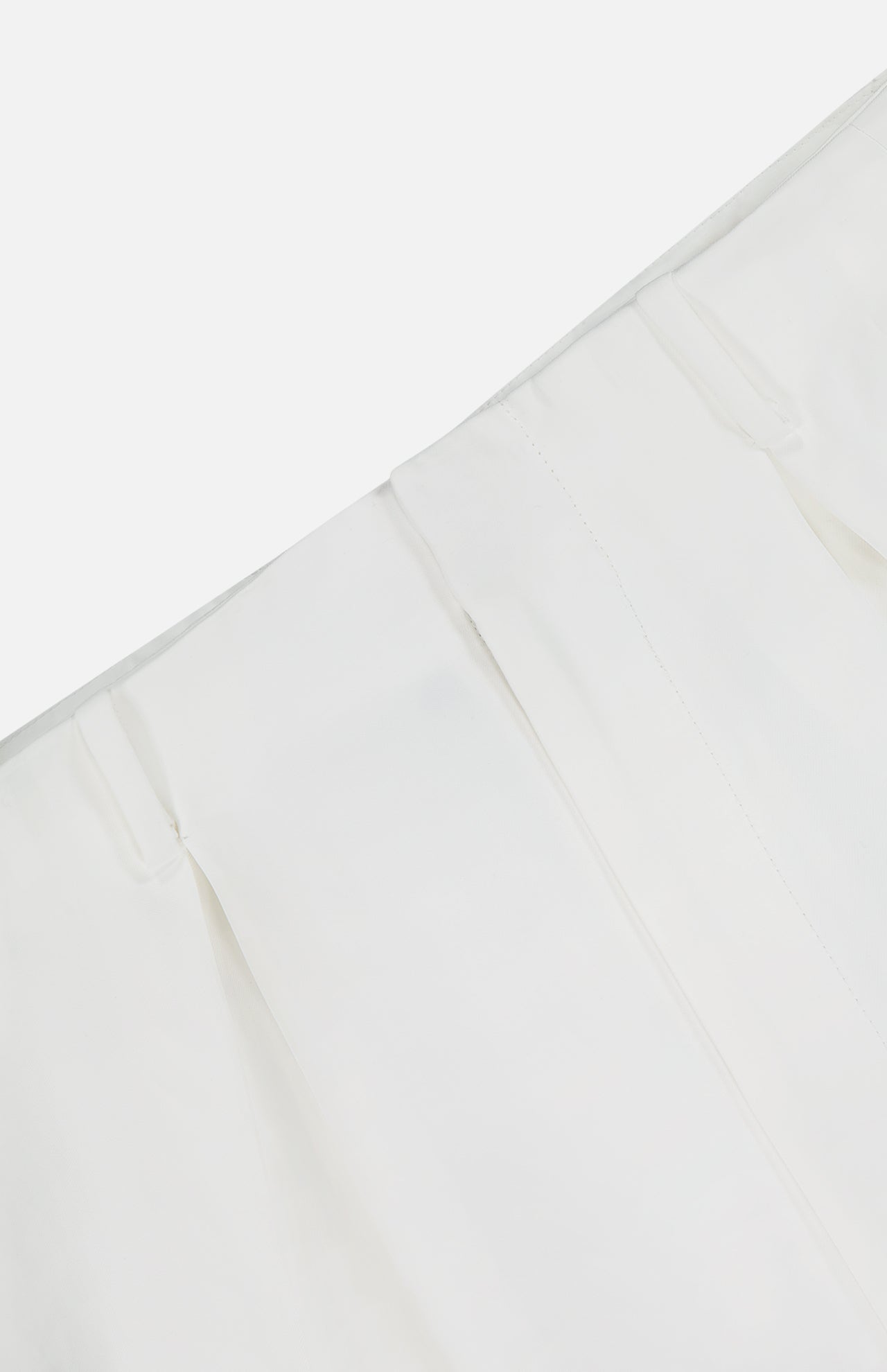 A close-up of the Greer Pleated Viscose Trouser Pants by RALPH LAUREN COLLECTION in white, featuring neatly sewn pleats and a high-rise design for a structured, elegant look against a plain background.