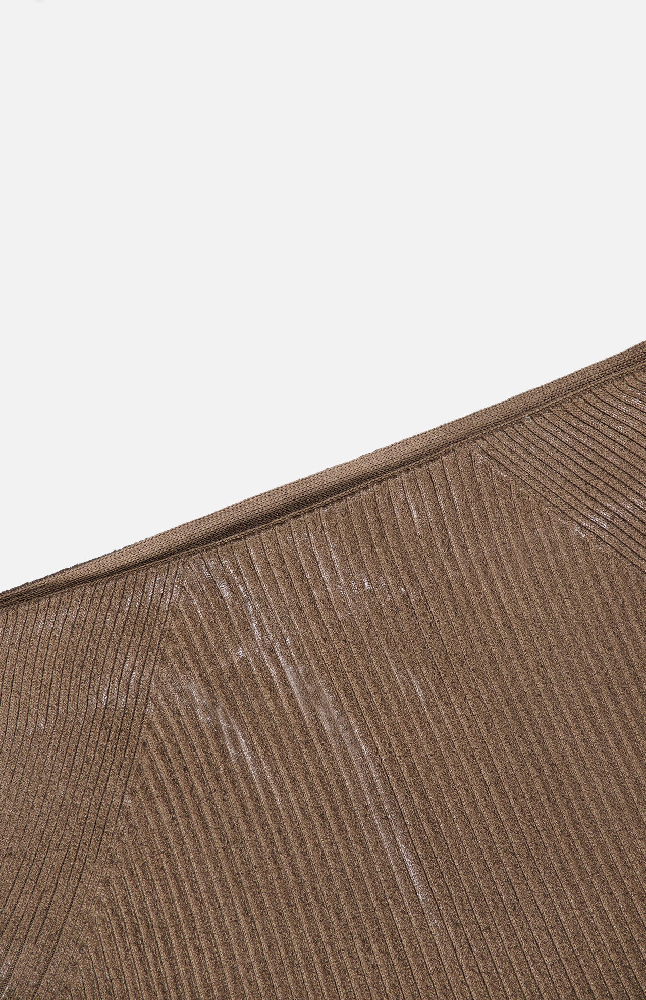 Close-up of the Adrianna Silk Skirt by RALPH LAUREN COLLECTION, featuring a ribbed brown fabric with visible white marks and diagonal seam lines, set against a plain white background.
