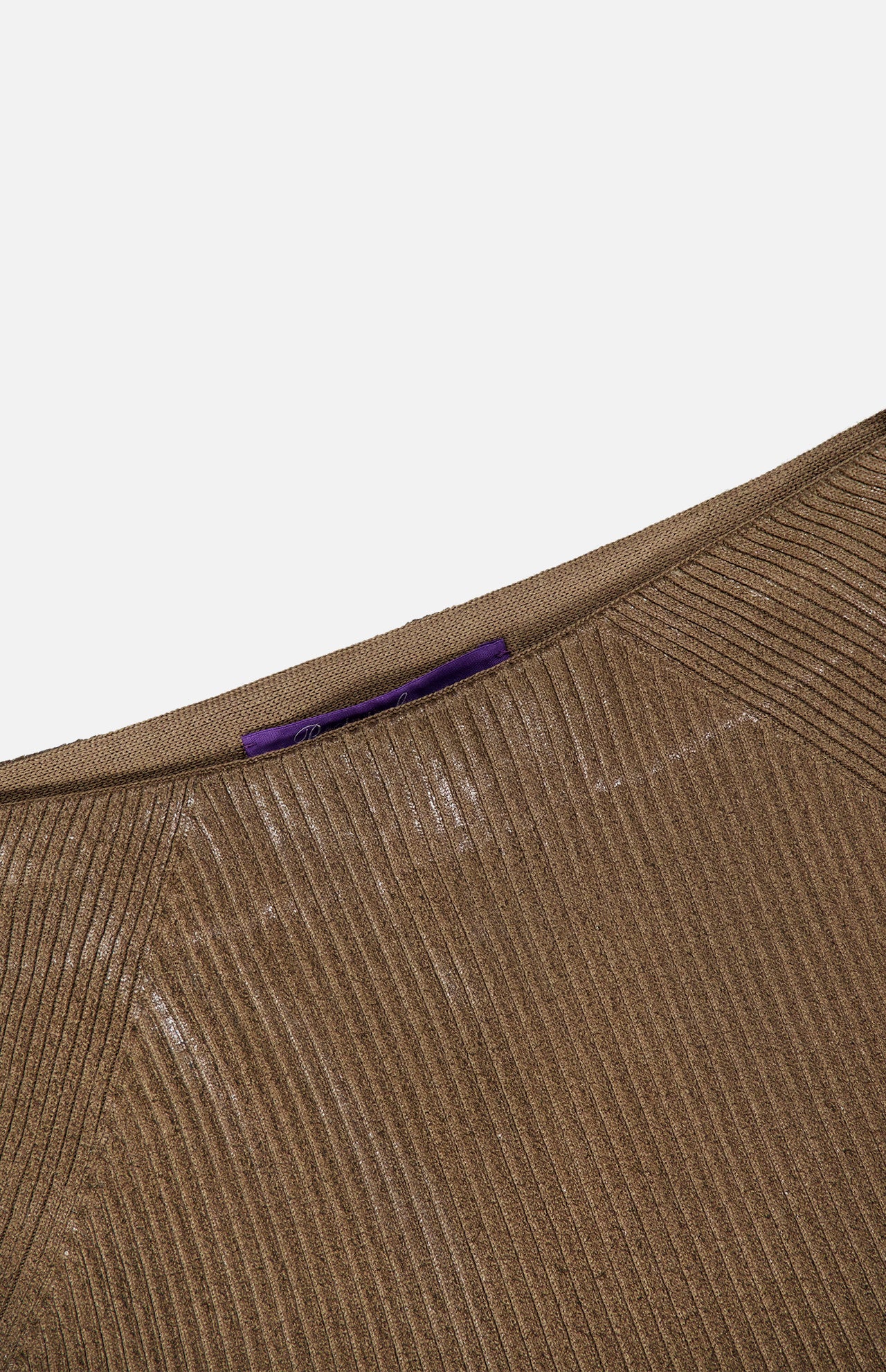 Close-up of the top portion of the Adrianna Silk Skirt by RALPH LAUREN COLLECTION, showcasing a brown ribbed knit texture with a subtle shimmer and a purple tag at the inner waistband, set against a white background.