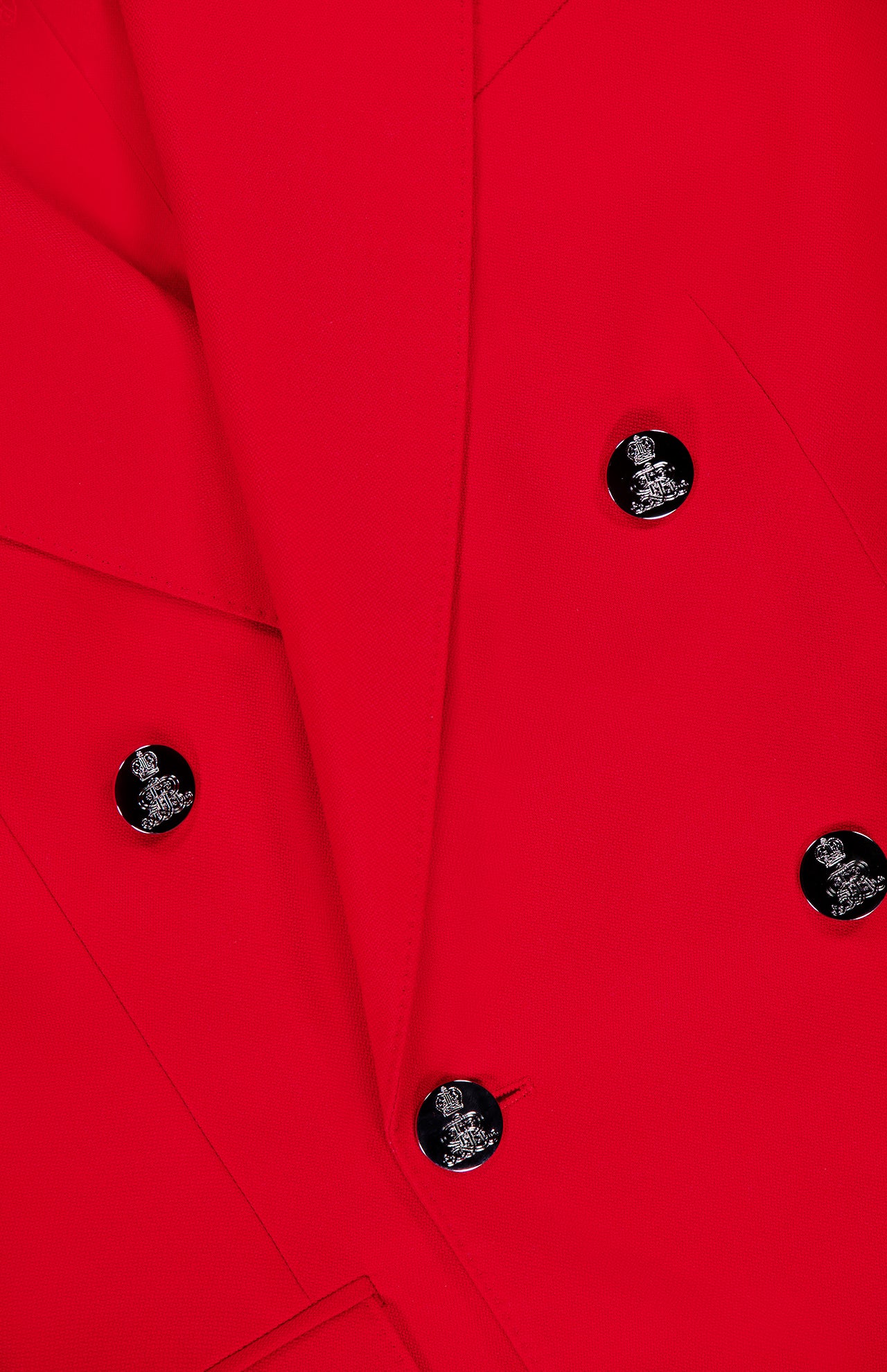 Close-up of the Camden Cashmere Jacket by RALPH LAUREN COLLECTION, a vivid red double-breasted blazer with six black buttons featuring silver accents. Overlapping lapels and structured fabric stand out in this elegant design.