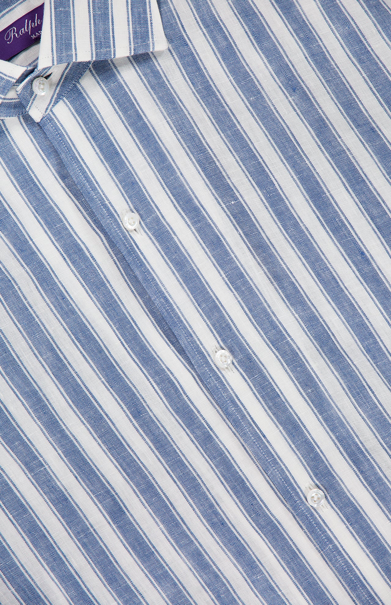 A close-up of the Capri Long Sleeve Button Front Shirt by RALPH LAUREN COLLECTION, featuring blue and white vertical stripes, white buttons, and a visible collar.