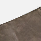 A detailed close-up of the Carreen Leather Mini Pencil Skirt by RALPH LAUREN COLLECTION, showcasing the rich brown lambskin leather fabric with visible texture and precise stitching, set against a plain white background.
