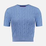 The RALPH LAUREN COLLECTION Cashmere Classic Cropped Pullover Sweater features a light blue cable knit, short sleeves, crew neckline, and ribbed hem. This slim-fit sweater offers a flattering silhouette and timeless style on a white background.