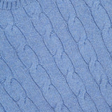 Close-up of the light blue Cashmere Classic Cropped Pullover Sweater by RALPH LAUREN COLLECTION, showcasing a purple label at the neckline for a signature, timeless look.