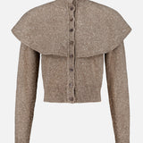 The Cashmere Turtleneck Cardigan Sweater by RALPH LAUREN COLLECTION is a taupe, knit long-sleeve piece featuring a high collar, front buttons, and a wide cape overlay across the shoulders.