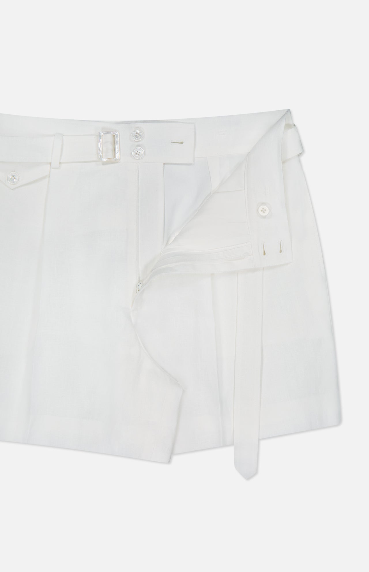 The Denise Classic Linen Shorts by RALPH LAUREN COLLECTION, styled partially unzipped, have a button closure, waist belt with loops, and visible inner lining—ideal for summer suiting—displayed on a plain white background.