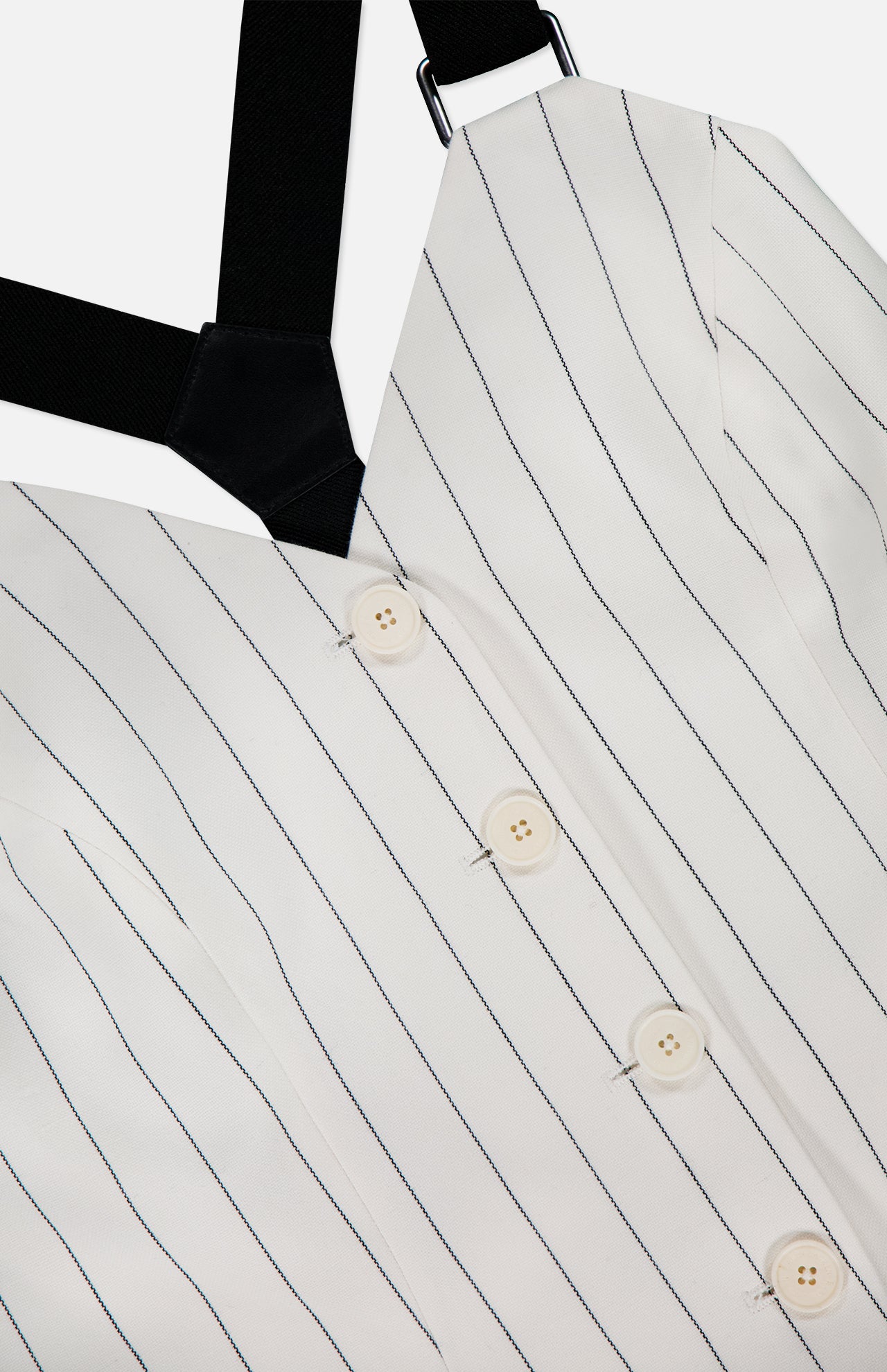 Close-up of the Donella Sleeveless Blouse by RALPH LAUREN COLLECTION: an off-white women’s bustier top with vertical black pinstripes, four white buttons, and a wide black strap—a chic take on tuxedo style.