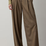 RALPH LAUREN COLLECTION Fine Wool Standard Pants in brown, featuring a high-waisted, relaxed fit with a single front pleat, worn with a muted green button-down shirt.