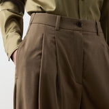 Ralph Lauren Collection Fine Wool Standard Pants in brown, featuring a relaxed-fit, high waist, single front pleat, and side pockets, worn with an olive button-down shirt.