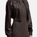 A person wears a dark brown Ralph Lauren Collection Grained Leather Bomber Jacket over a matching textured knit dress.
