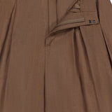 Close-up of the Greer Full Length Pleated Pant by RALPH LAUREN COLLECTION, featuring a textured brown fabric, high rise wide leg, and partially open waistband revealing zipper, clasp, and interior details.