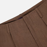 Close-up of the Greer Full Length Pleated Pant from RALPH LAUREN COLLECTION, highlighting the brown high-rise wide leg waistband with belt loops against a plain white background.