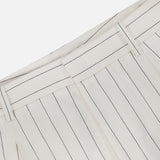 Close-up of RALPH LAUREN COLLECTION Harlo Pleated Stripe Suit Pants in off-white with thin black pinstripes, carrot silhouette, belt loops, and a waistband shown against a plain white background.