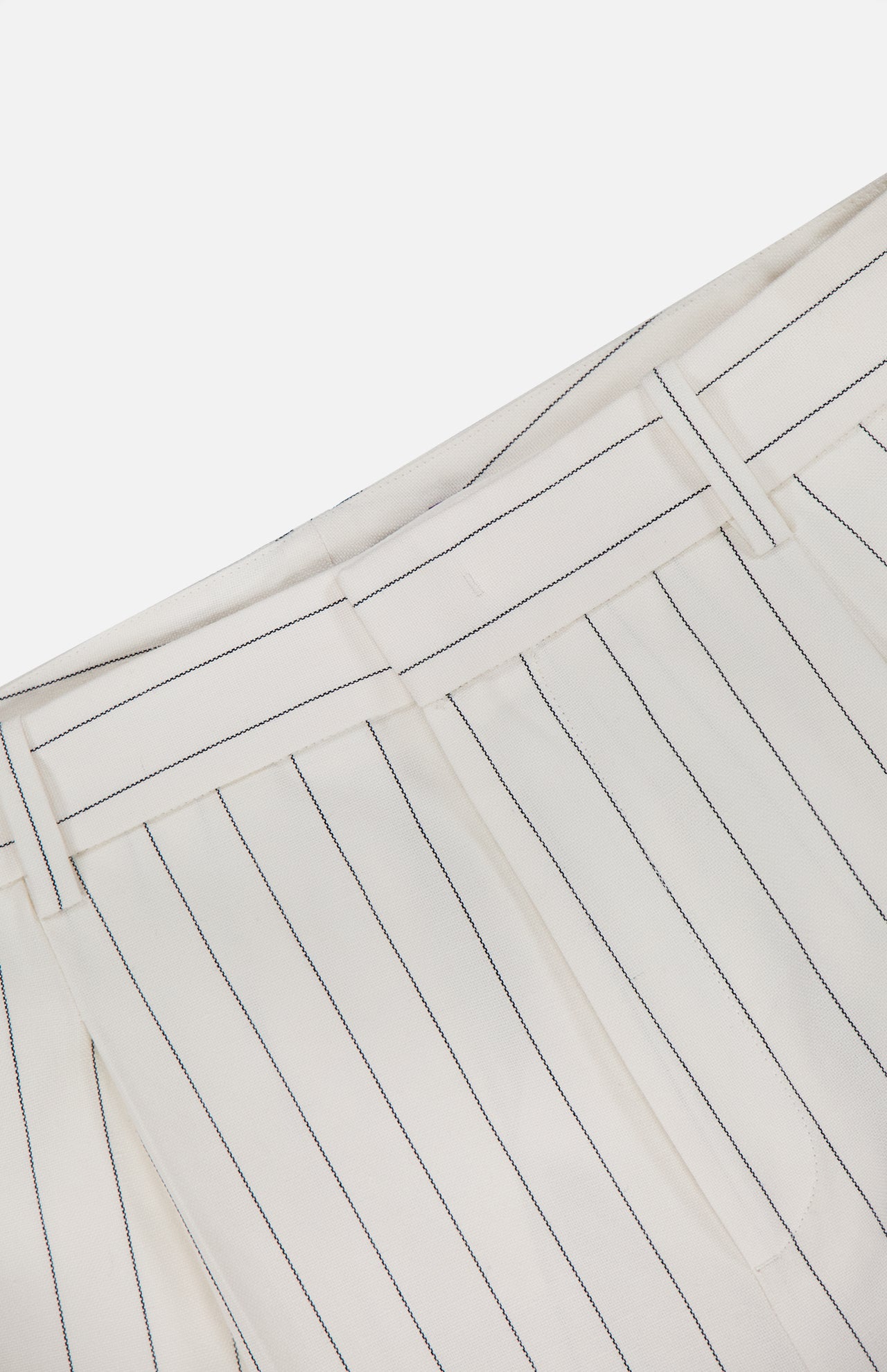 Close-up of RALPH LAUREN COLLECTION Harlo Pleated Stripe Suit Pants in off-white with thin black pinstripes, carrot silhouette, belt loops, and a waistband shown against a plain white background.